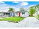 Cozy home with a well-maintained lawn, a stone driveway, and a vibrant red front door at 2021 Reformers Ave, Indianapolis, IN 46203