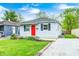 Charming single-story home with a well-maintained lawn, a red door, and inviting curb appeal at 2021 Reformers Ave, Indianapolis, IN 46203