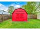 Charming red shed with double doors, perfect for storing garden equipment and tools at 2021 Reformers Ave, Indianapolis, IN 46203