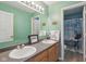 Well-lit bathroom with double sinks, oak cabinets, and a separate shower/toilet area at 2116 Crimson Ln, Lebanon, IN 46052