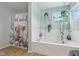 Bright bathroom with a tub and shower with hanging plants and unique accessories at 2116 Crimson Ln, Lebanon, IN 46052