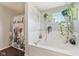 Bathroom showing a bathtub, shower curtain, and several hanging plants at 2116 Crimson Ln, Lebanon, IN 46052