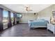 Large bedroom with dark wood floors, a ceiling fan, and a large window at 2116 Crimson Ln, Lebanon, IN 46052