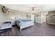 Bedroom showcasing dark wood floors, ceiling fan, ample lighting, and a small bed at 2116 Crimson Ln, Lebanon, IN 46052