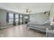 Airy bedroom with laminate floors, three large windows, and modern lighting at 2116 Crimson Ln, Lebanon, IN 46052
