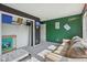 Bedroom featuring neutral carpet, black and green accent wall and walk in closet at 2116 Crimson Ln, Lebanon, IN 46052