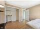 Bright bedroom featuring neutral walls, wood floors, a walk-in closet, and an open doorway at 2116 Crimson Ln, Lebanon, IN 46052