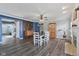 Open-concept dining room with wood floors, modern lighting, and stylish sliding barn door at 2116 Crimson Ln, Lebanon, IN 46052