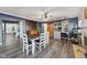 Open dining room with stylish gray plank flooring, a ceiling fan, and blue accent wall at 2116 Crimson Ln, Lebanon, IN 46052