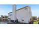 View of the home's exterior with gray siding, a tall chimney, and a patio area at 2116 Crimson Ln, Lebanon, IN 46052