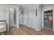 Bright hallway featuring wood floors, storage and doors to bedroom closets at 2116 Crimson Ln, Lebanon, IN 46052