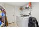 Functional laundry area with washer, dryer, and storage shelving for supplies at 2116 Crimson Ln, Lebanon, IN 46052