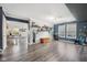 Bright and open living room with wood floors, open concept, and natural light streaming through the windows at 2116 Crimson Ln, Lebanon, IN 46052