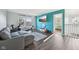 Open living space featuring wood-look floors, workout equipment, a large television, and modern furnishings at 2116 Crimson Ln, Lebanon, IN 46052