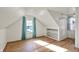 Finished attic bedroom with storage shelving, painted white paneling, and a window at 2221 Douglas Rd, Indianapolis, IN 46220
