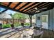 A well-maintained outdoor back porch featuring a ceiling fan and a backyard view at 2221 Douglas Rd, Indianapolis, IN 46220