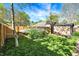 Fenced backyard with a storage shed, potential space for a hot tub, and lush green grass at 2221 Douglas Rd, Indianapolis, IN 46220