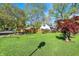Spacious backyard featuring a lush lawn, a wooden fence, and mature trees at 2221 Douglas Rd, Indianapolis, IN 46220