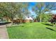 Large backyard with green lawn, wood fence, and mature trees providing ample shade at 2221 Douglas Rd, Indianapolis, IN 46220