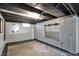 A view of the unfinished basement showing built in storage and a rug on the floor at 2221 Douglas Rd, Indianapolis, IN 46220