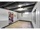 An unfinished basement featuring painted walls and ceiling with concrete floors covered by a large area rug at 2221 Douglas Rd, Indianapolis, IN 46220