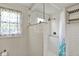 Bathroom with glass enclosed shower, window with curtain, and open shelving at 2221 Douglas Rd, Indianapolis, IN 46220