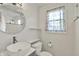 Bathroom featuring white finishes, a unique round mirror, and a vessel sink at 2221 Douglas Rd, Indianapolis, IN 46220