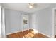 Bedroom with neutral walls, hardwood floors, and natural light through windows at 2221 Douglas Rd, Indianapolis, IN 46220