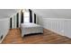 Bedroom featuring hardwood floors, a window and gray paneled walls at 2221 Douglas Rd, Indianapolis, IN 46220