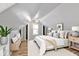 Cozy bedroom featuring vaulted ceilings, neutral decor, and ample natural light at 2221 Douglas Rd, Indianapolis, IN 46220