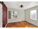 Bedroom featuring hardwood floors, accent wall, windows, and modern lighting at 2221 Douglas Rd, Indianapolis, IN 46220