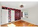 Spacious bedroom with hardwood floors, accent wall, and natural light at 2221 Douglas Rd, Indianapolis, IN 46220