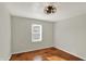This bedroom features hardwood floors, neutral walls, and a modern ceiling light at 2221 Douglas Rd, Indianapolis, IN 46220