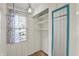Attic bedroom walk-in closet with a window and storage shelves at 2221 Douglas Rd, Indianapolis, IN 46220