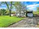 Inviting blue home with a well-manicured lawn, a paved driveway, and a detached garage at 2221 Douglas Rd, Indianapolis, IN 46220