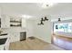 Bright kitchen with white cabinets, stainless steel appliances and an open view to the living room at 2221 Douglas Rd, Indianapolis, IN 46220