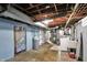 The basement laundry area has a washer, dryer, utility sink, and water softener at 2221 Douglas Rd, Indianapolis, IN 46220