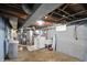 The basement laundry area contains a washer, dryer, utility sink, and water softener at 2221 Douglas Rd, Indianapolis, IN 46220