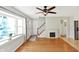 Sunlit living room with hardwood floors, a cozy fireplace, and direct access to the entry foyer at 2221 Douglas Rd, Indianapolis, IN 46220