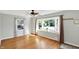 Bright living room featuring hardwood floors, large windows, and modern ceiling fan at 2221 Douglas Rd, Indianapolis, IN 46220