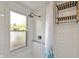 Bright shower with white subway tile and a shower curtain with blue leaves at 2221 Douglas Rd, Indianapolis, IN 46220