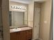 Bathroom featuring a vanity with a sink, a well-lit mirror and a shower at 2324 Harvest Moon Dr, Indianapolis, IN 46229