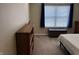 Bright bedroom featuring a window with blue curtains and a wooden chest at 2324 Harvest Moon Dr, Indianapolis, IN 46229