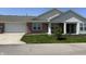 Charming brick home featuring an attached garage, well-manicured lawn, and inviting front porch at 2324 Harvest Moon Dr, Indianapolis, IN 46229
