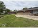 Expansive backyard with green lawn, mature trees, and patio area, perfect for outdoor entertaining at 2350 Brewer Dr, Indianapolis, IN 46227