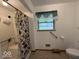 Bathroom featuring a tub/shower combo and grab bars for accessibility at 2350 Brewer Dr, Indianapolis, IN 46227