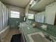 Vintage bathroom featuring dual sinks, tiled countertop, and floral wallpaper at 2350 Brewer Dr, Indianapolis, IN 46227