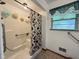 Accessible bathroom features a walk-in shower with safety grab bars and frosted window for natural light at 2350 Brewer Dr, Indianapolis, IN 46227