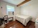 Bright bedroom with wood flooring, white walls, exposed beam, and ample natural light at 2350 Brewer Dr, Indianapolis, IN 46227