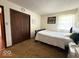 Bedroom featuring hardwood floors, a comfortable bed, and a spacious closet at 2350 Brewer Dr, Indianapolis, IN 46227